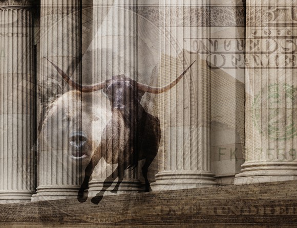 A bull,  bear, and $100 bill superimposed over the marble pillars outside a financial institution.