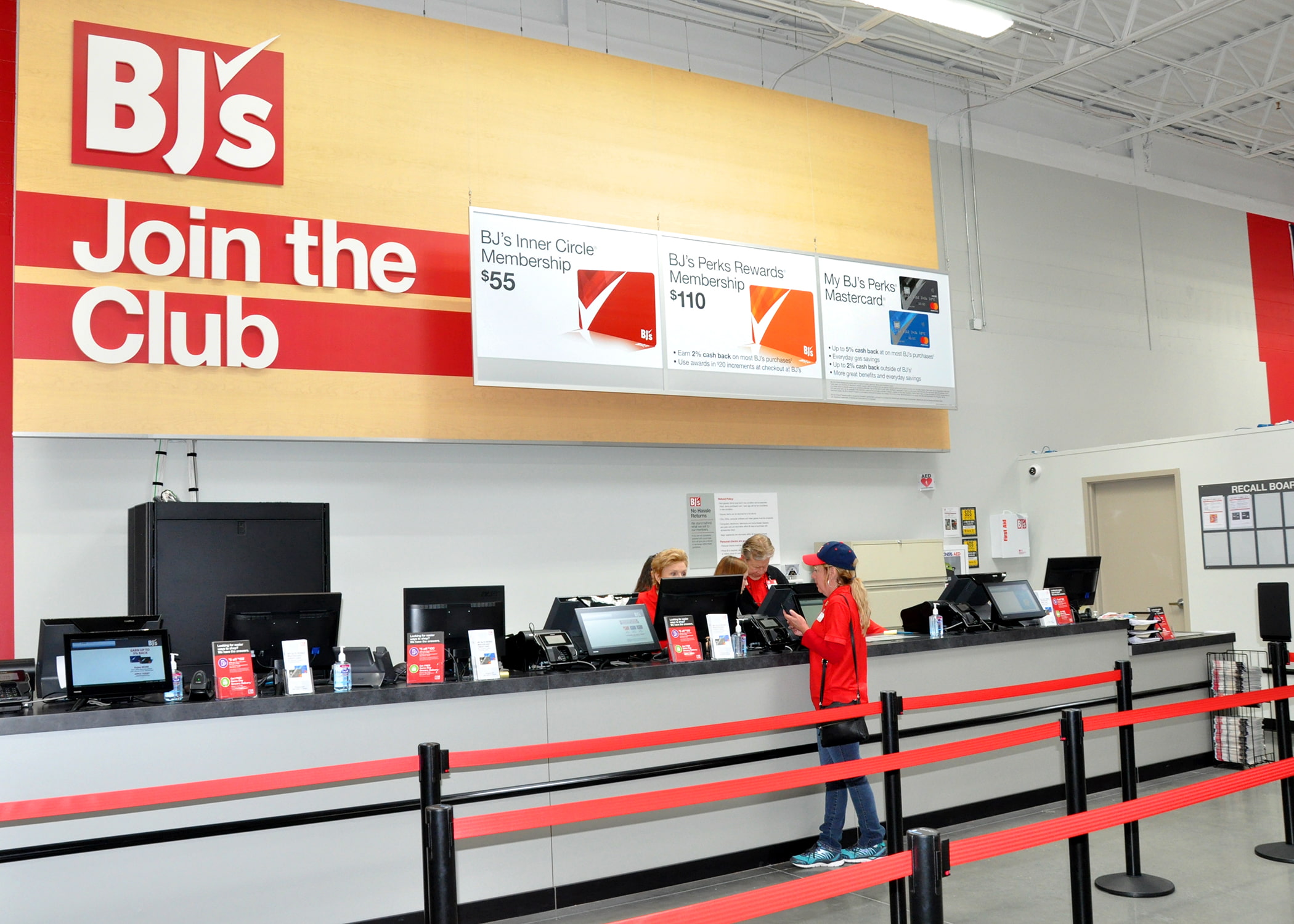 A BJ's Wholesale Club membership counter with a customer signing up.