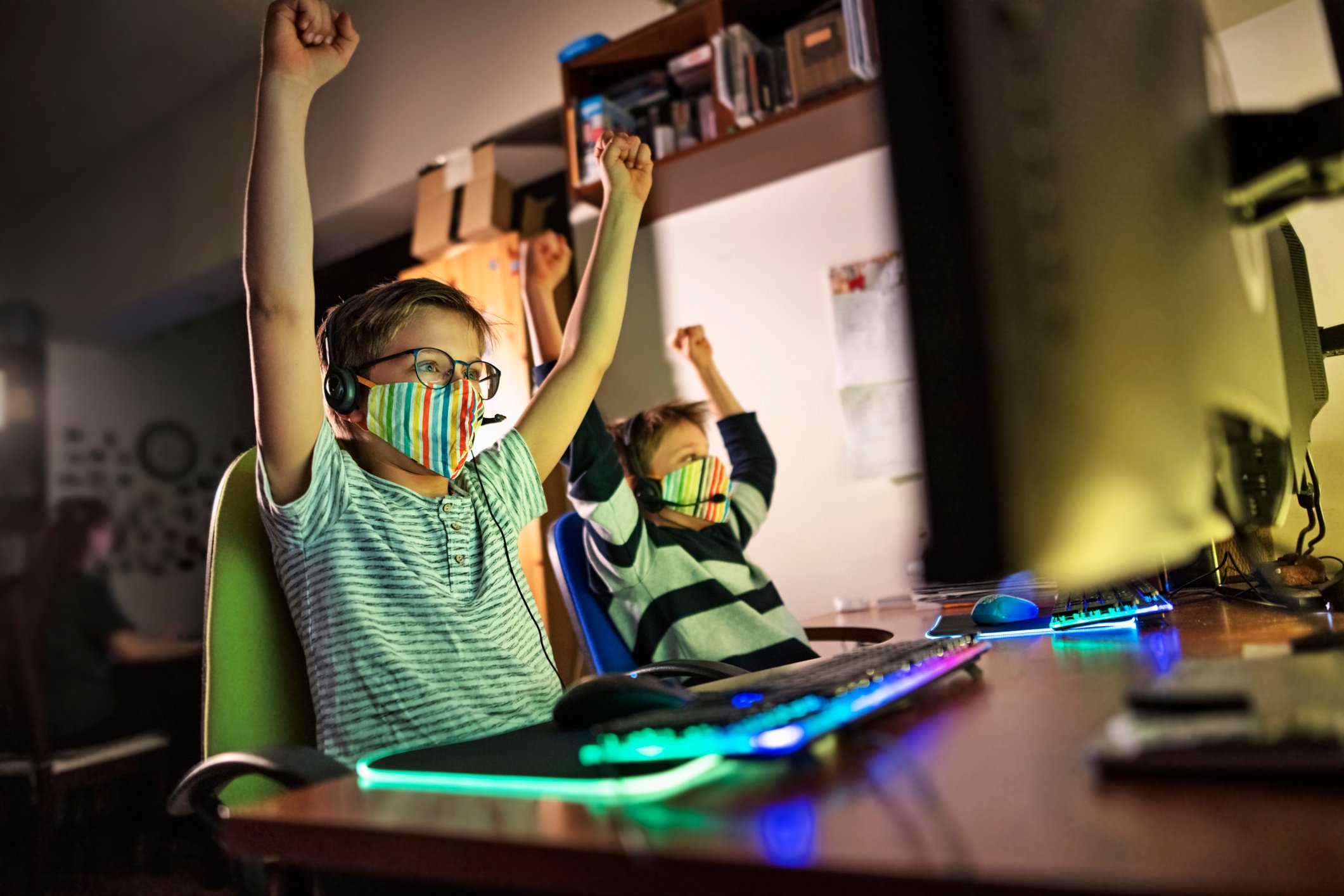 kids in masks playing online video game