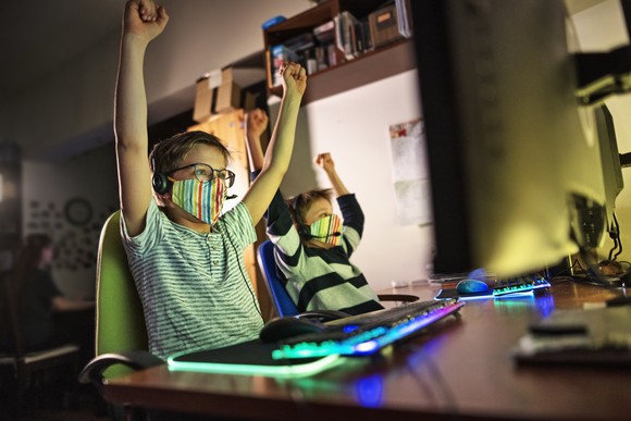 kids in masks playing online video game