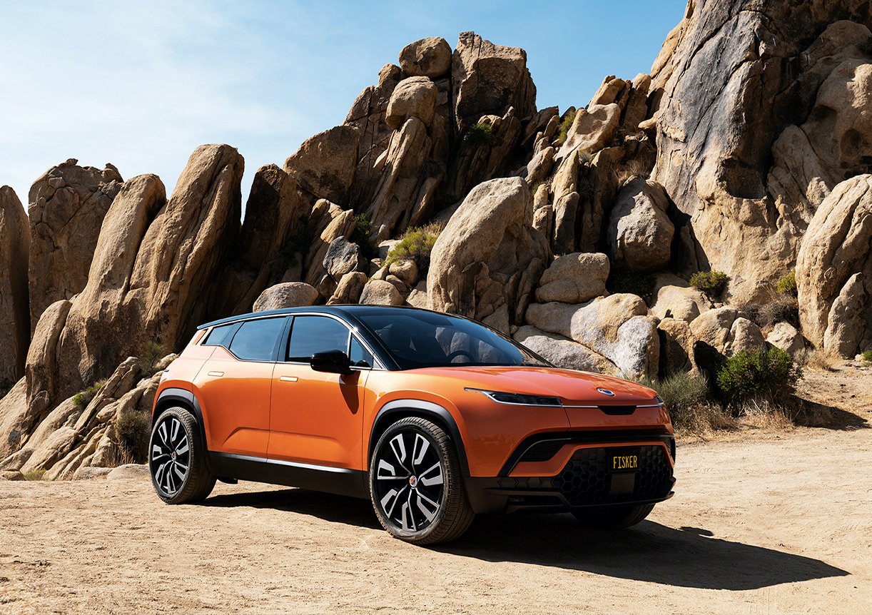 An orange Fisker Ocean, a prototype upscale electric SUV, on a California beach. 