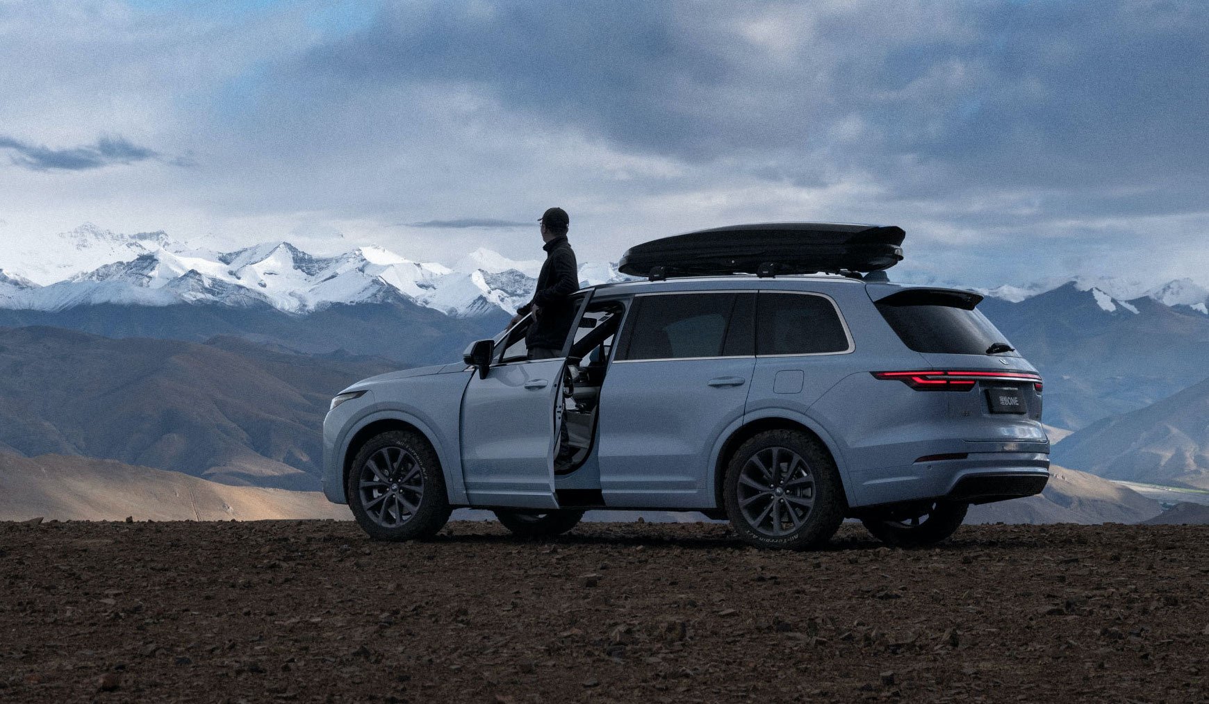 A Li ONE, an electric SUV, shown in a mountain area. 