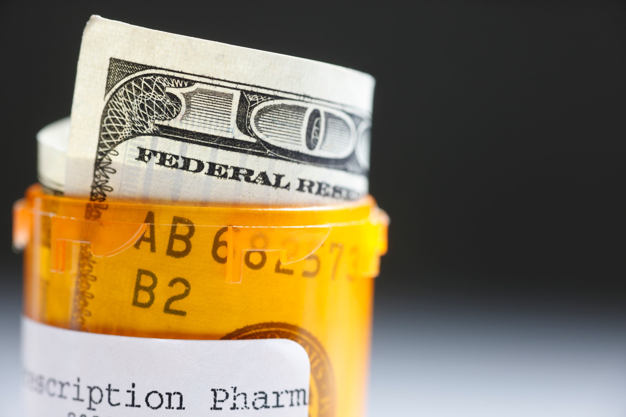 Hundred dollar bill in prescription bottle.