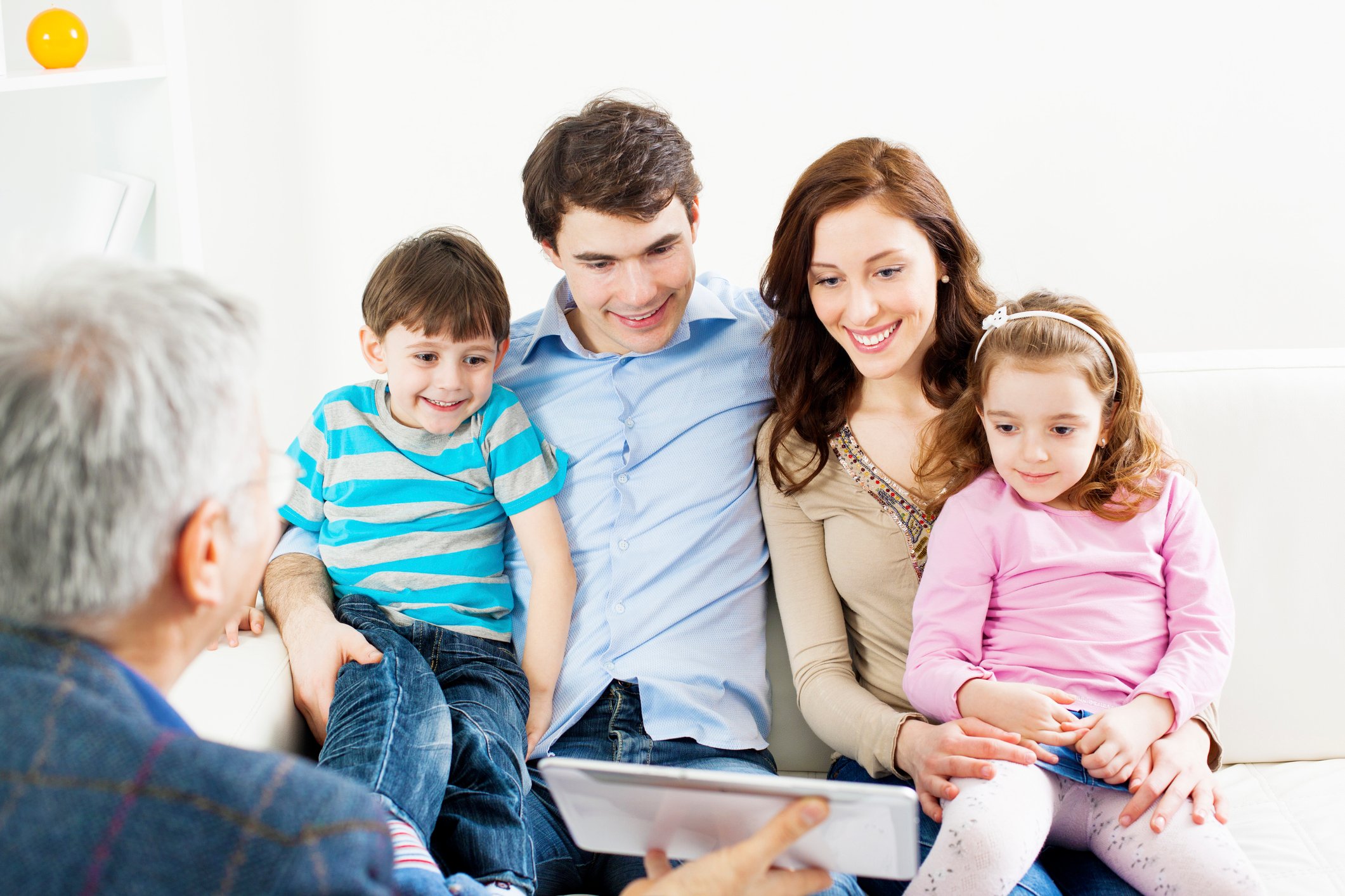 Family with two children Meeting With Senior Financial Advisor. 