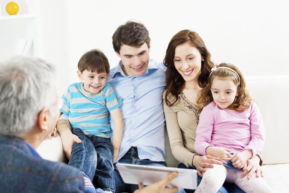 Family with two children Meeting With Senior Financial Advisor. 