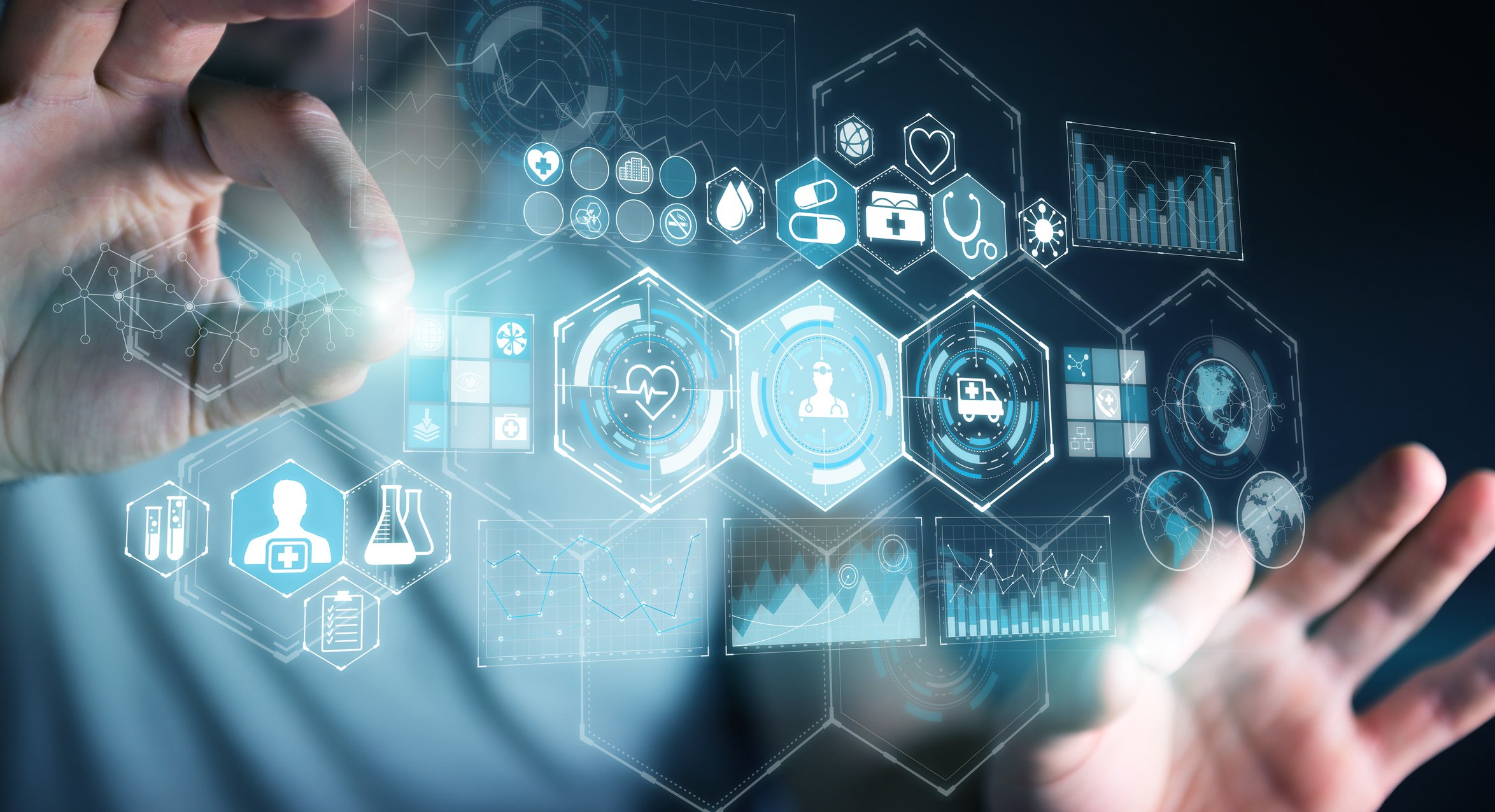 Hands held up to a projection of healthcare-related icons