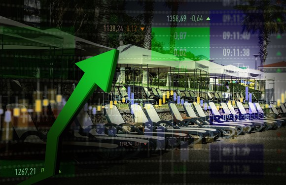 A digital stock graph with lounge chairs in the background.