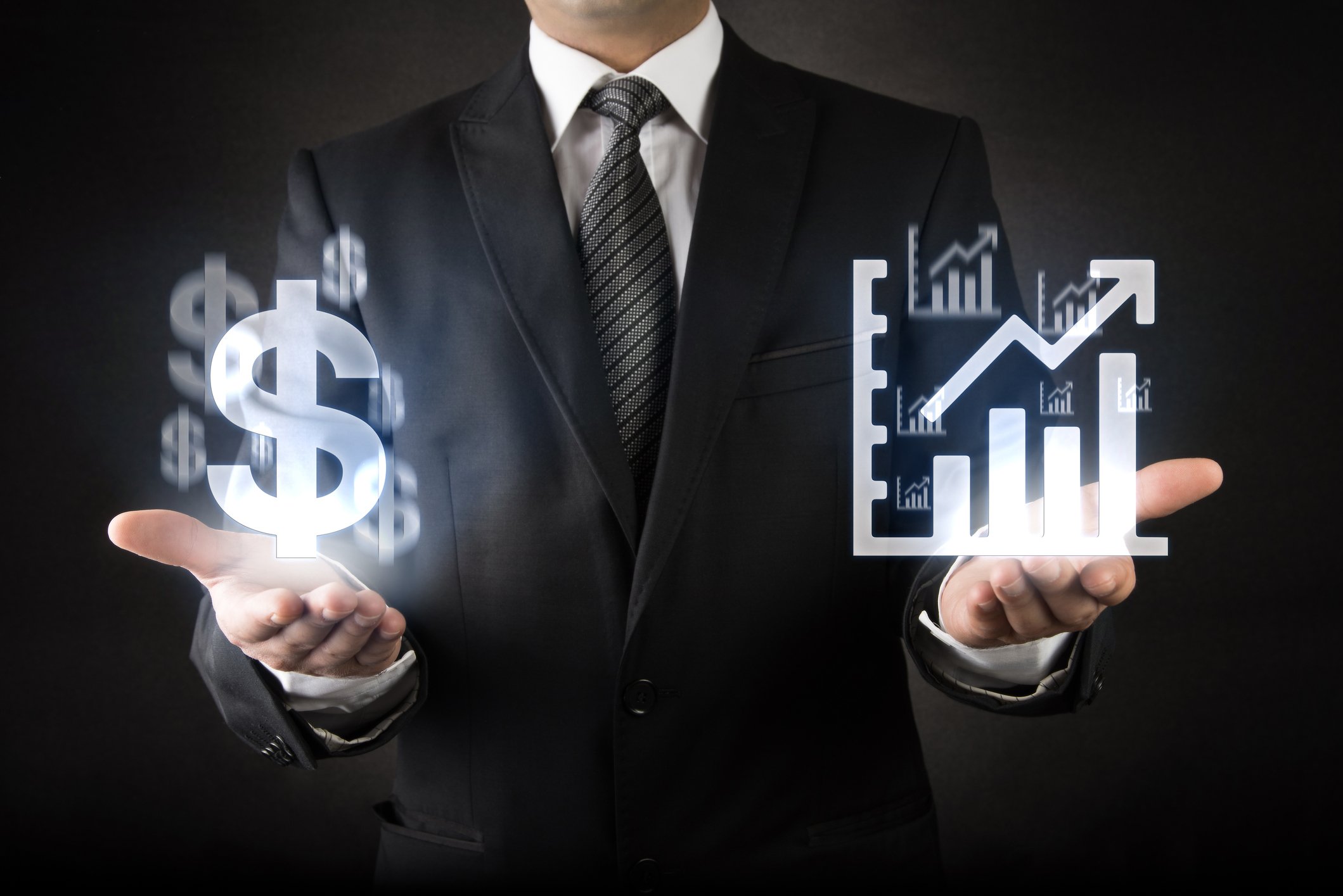 Man holding digital dollar sign and digital bar graph trending upward.