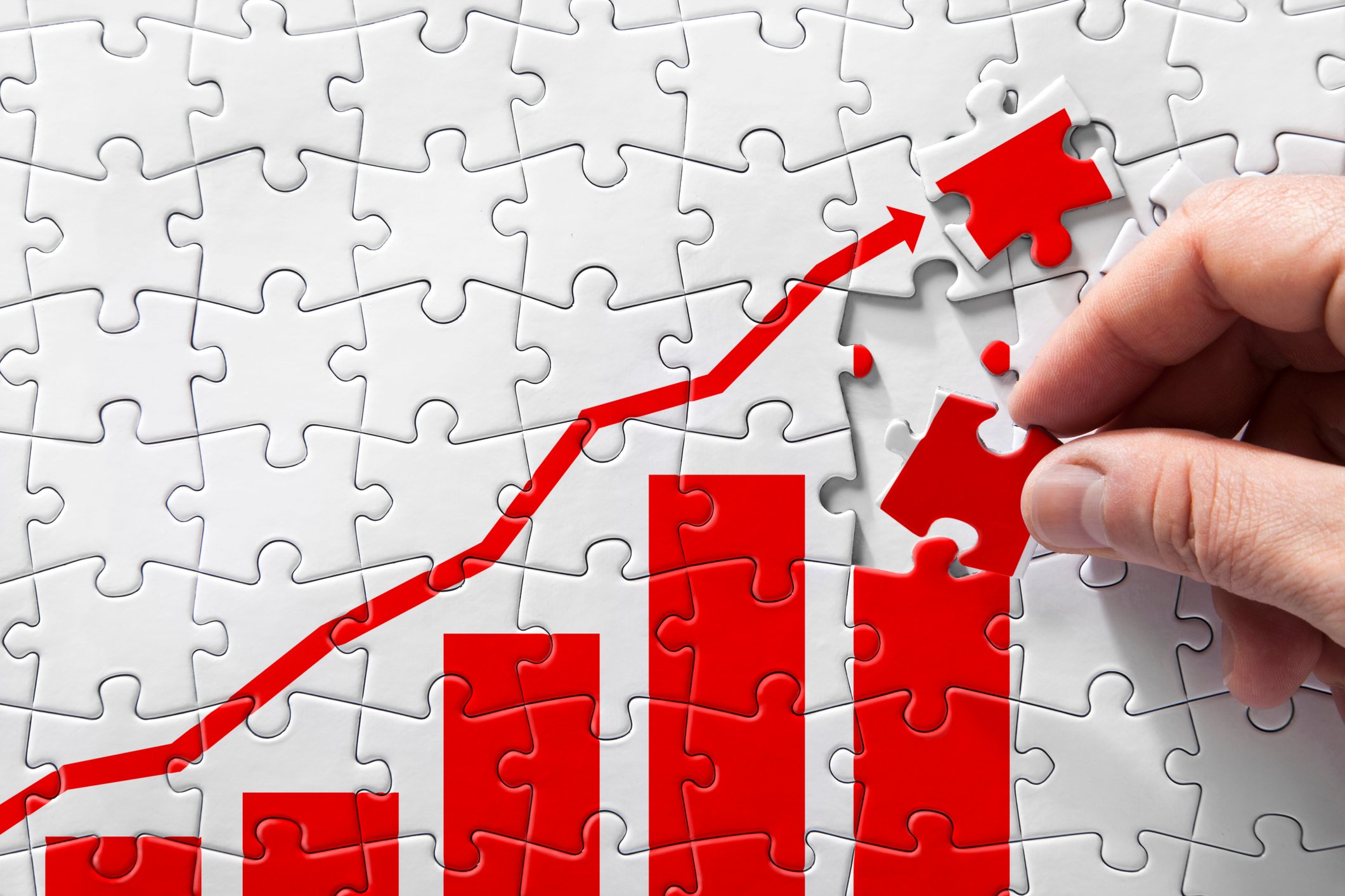 A puzzle of a rising chart being pieced together.