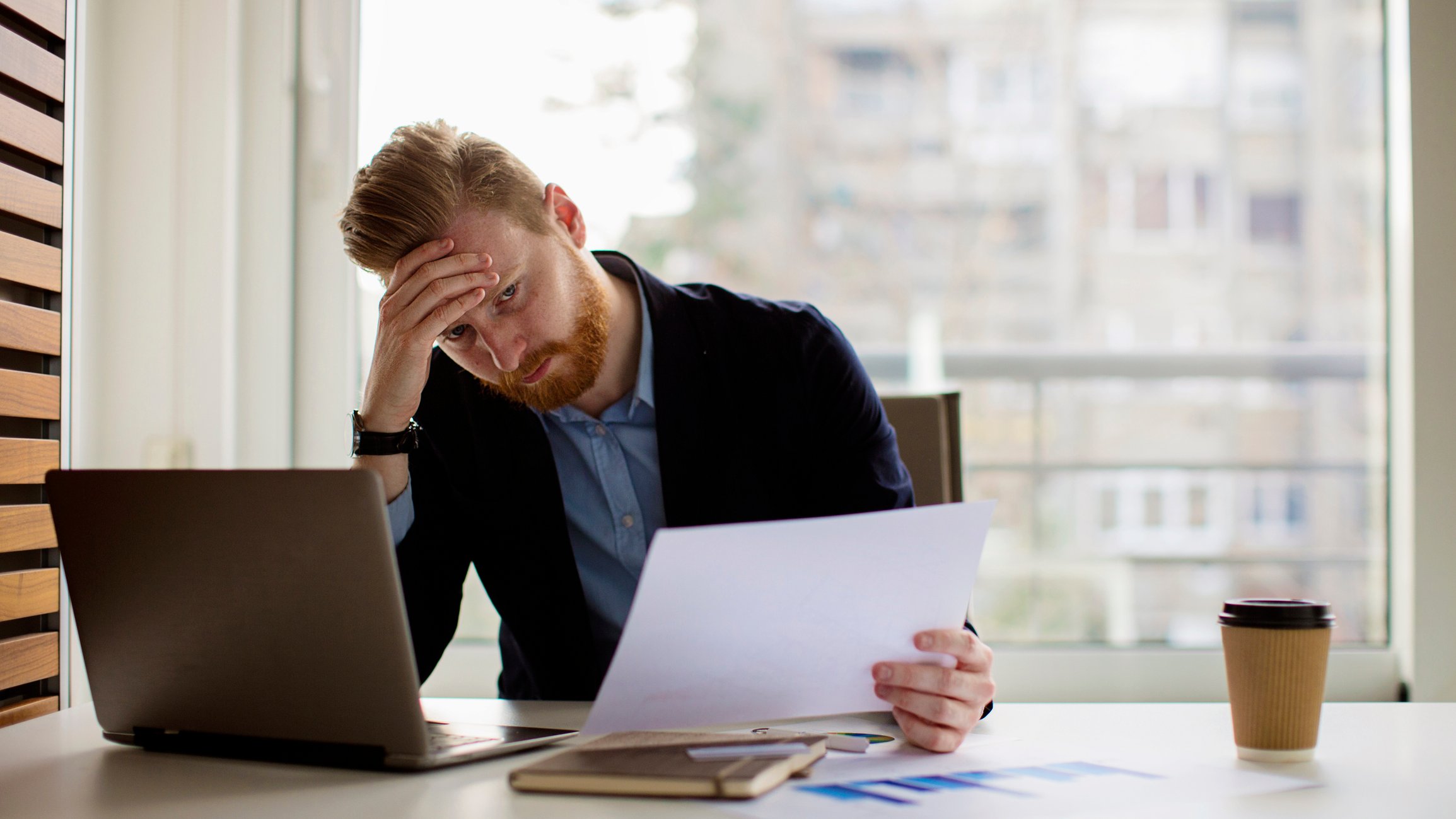 stressed accountant with hand on head