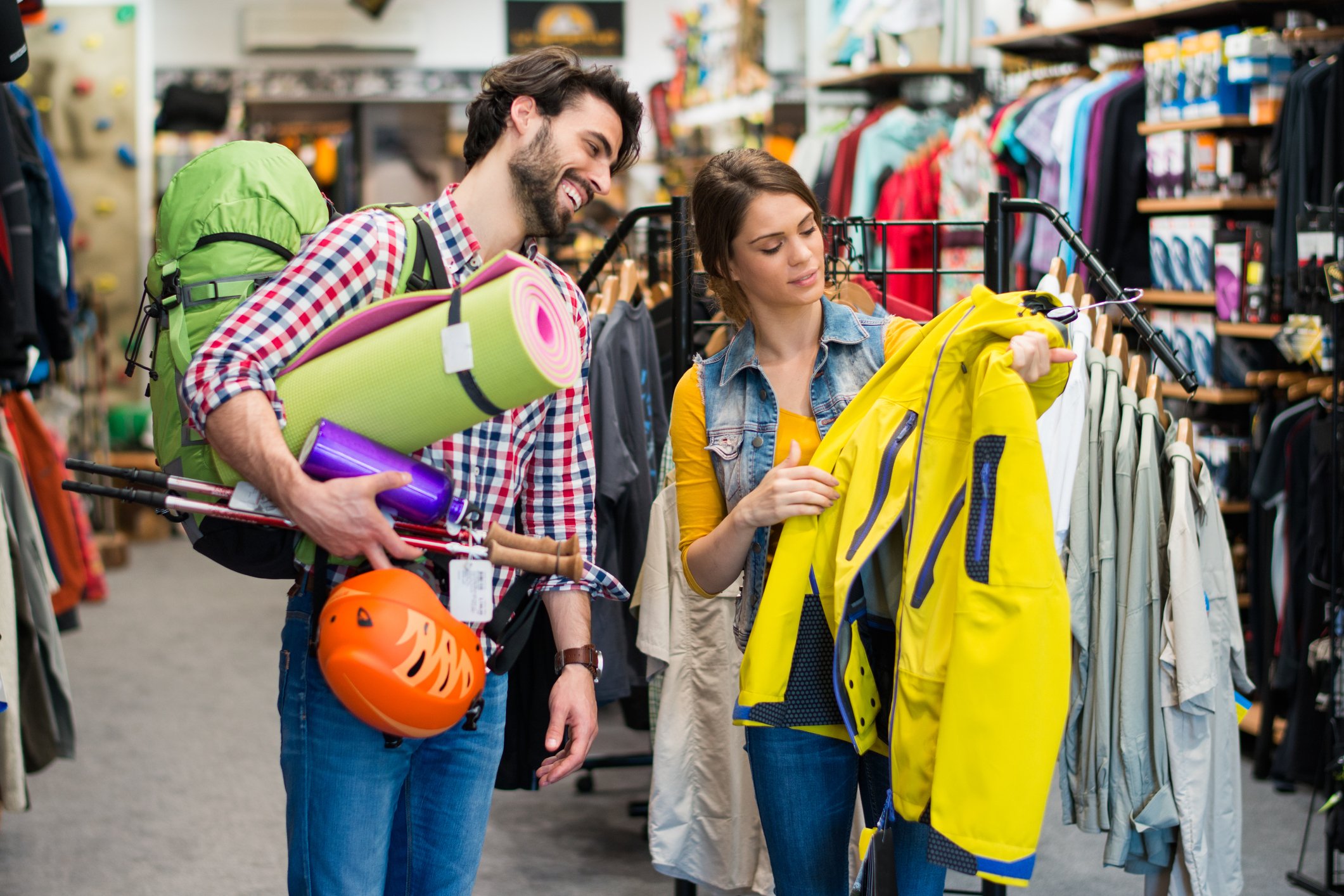 A couple shopping in a sporting goods store.