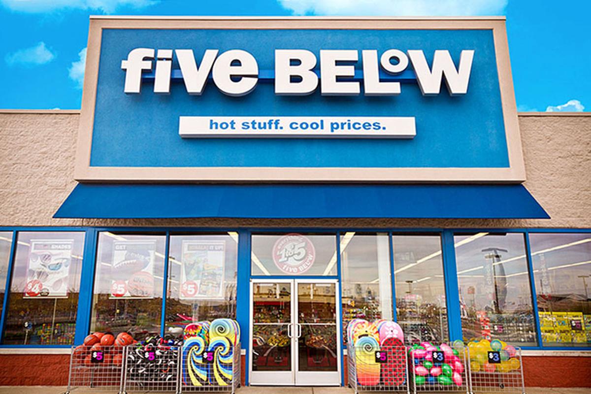 Exterior shot of a Five Below store with some items on display outside.