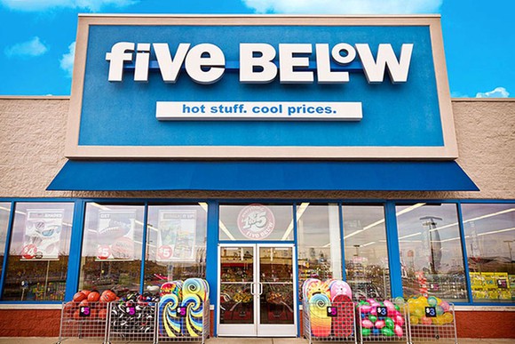 Exterior shot of a Five Below store with some items on display outside.