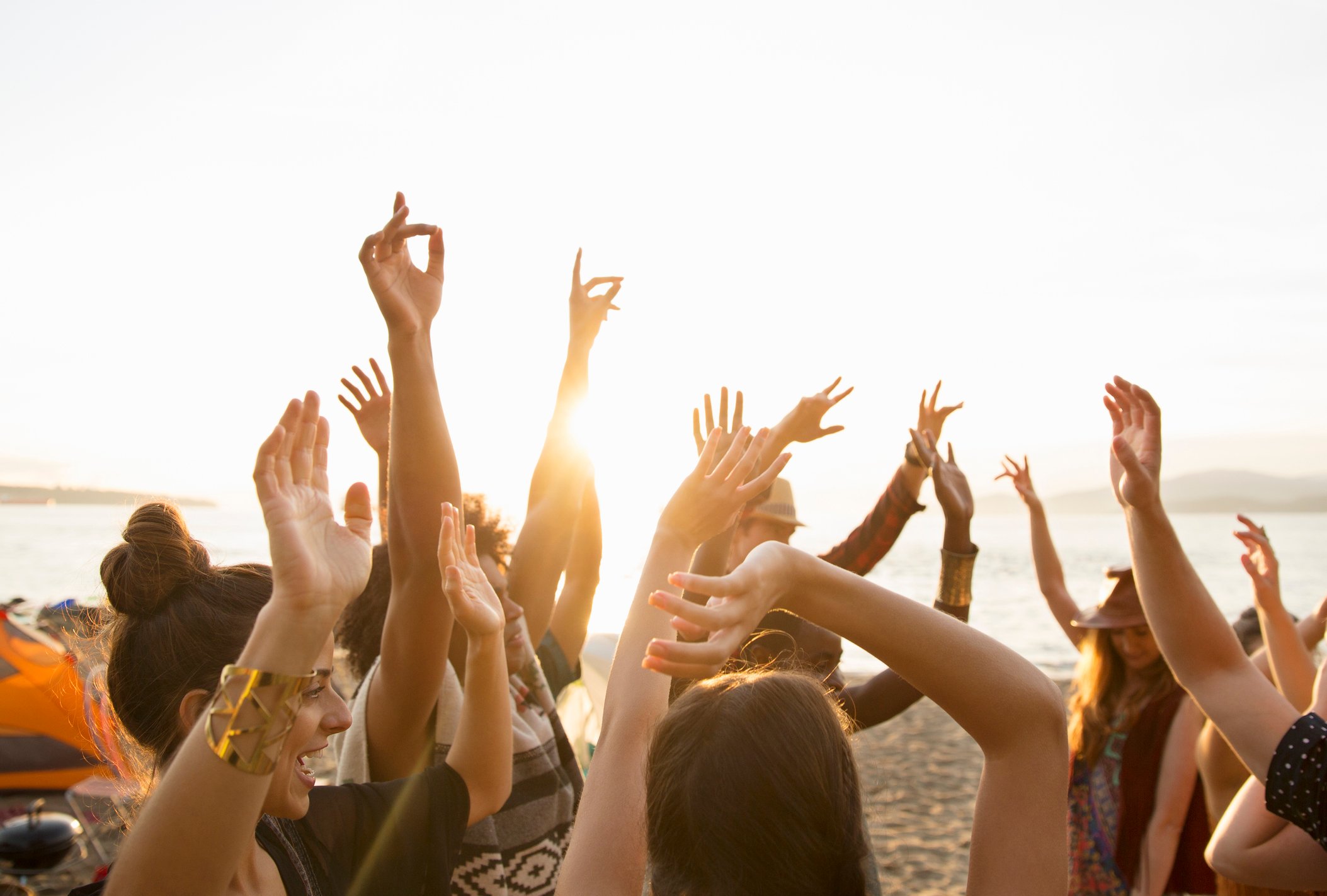 Young people at a party on a beach.