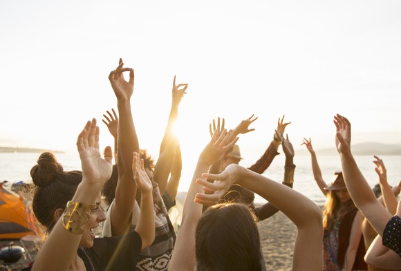 Young people at a party on a beach.