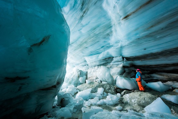 Person exploring a glacial cave