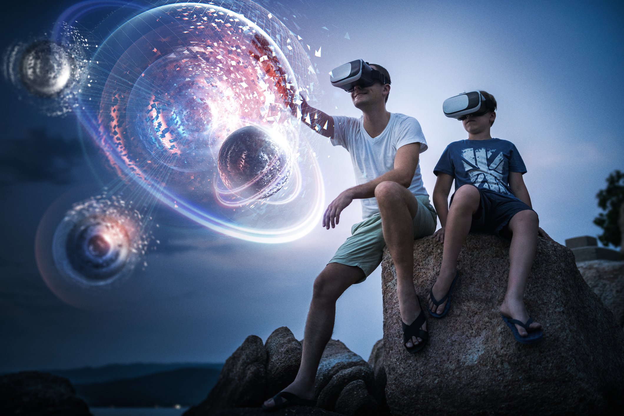 Adult man and young boy using AR headsets.
