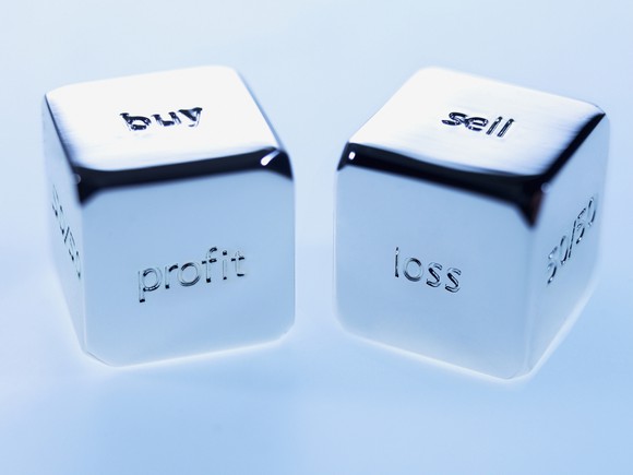 Silver cubes with buy and sell sayings on them