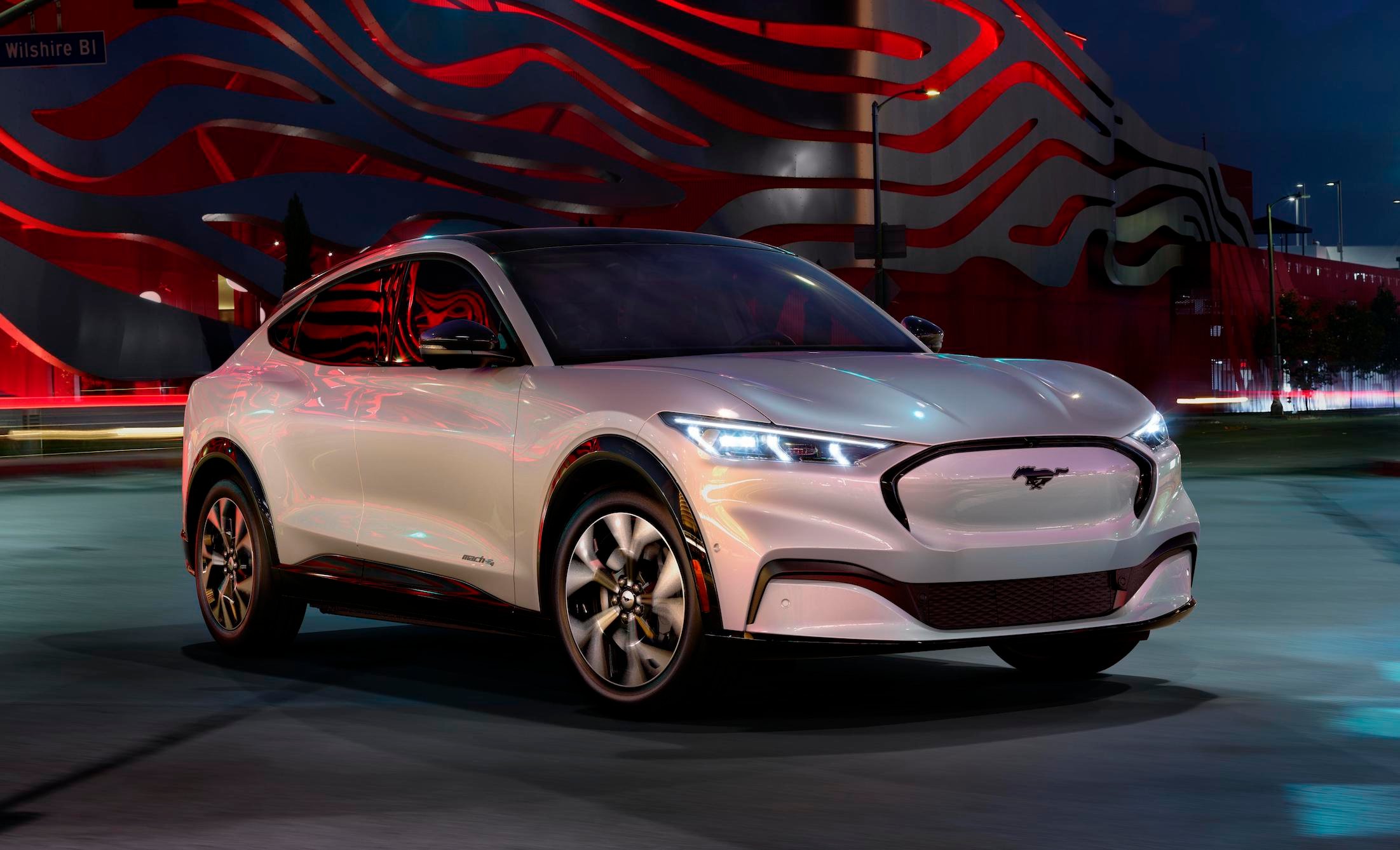 A silver Ford Mustang Mach-E, an electric performance crossover. 