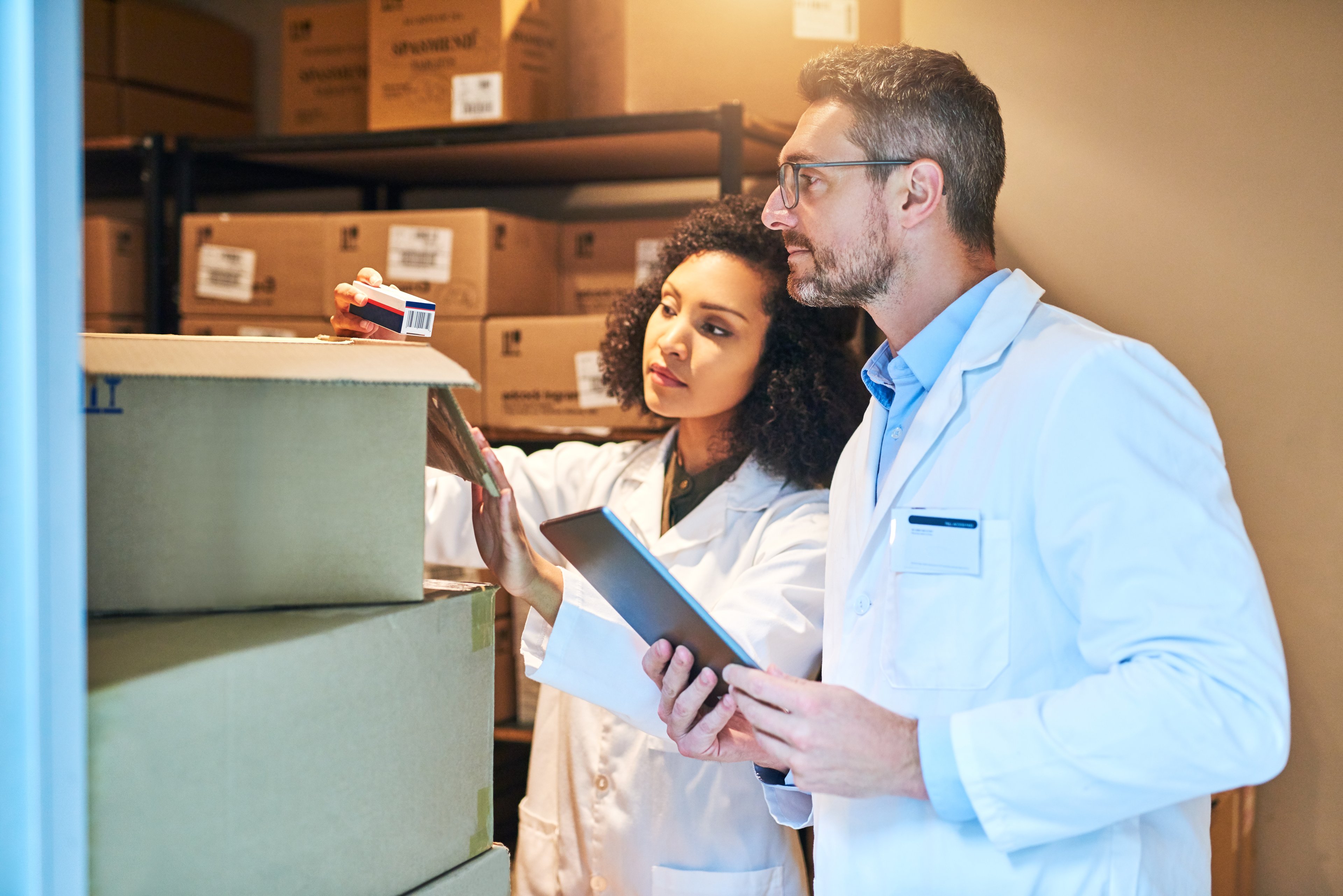 Pharmacists checking shipments in a warehouse. 