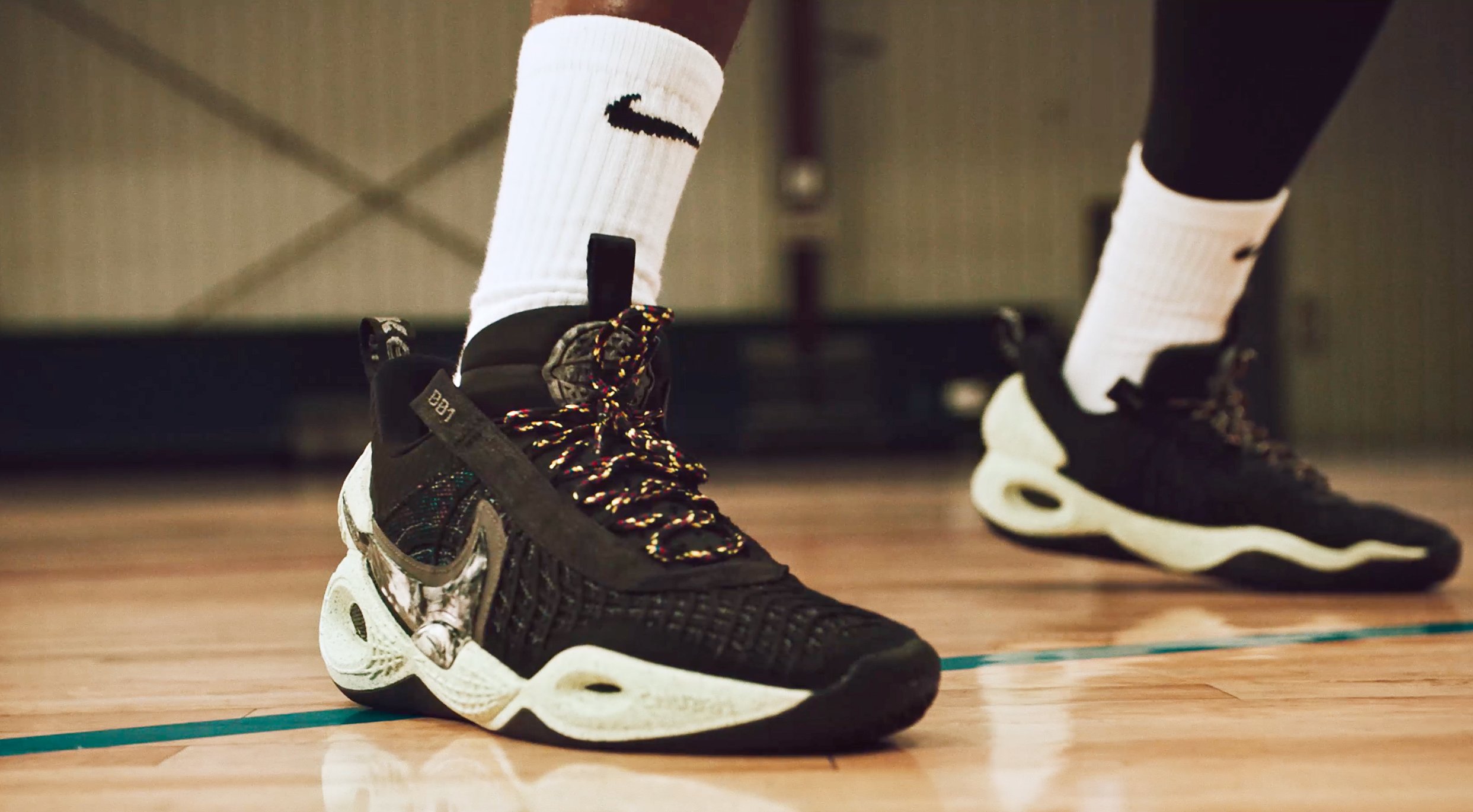 A basketball player's feet clad with Nike branded shoes and socks.