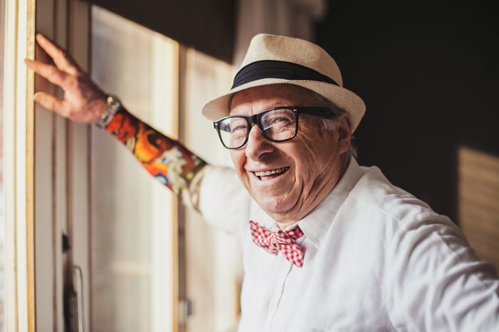 An older man smiles for the camera.