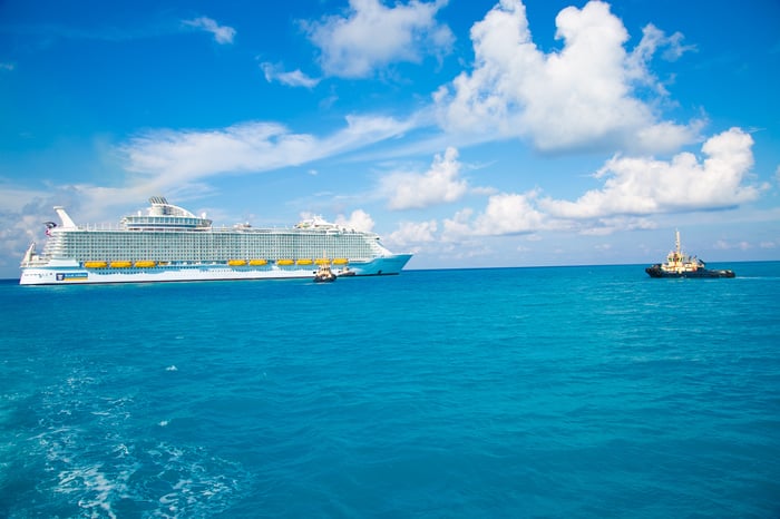 Royal Caribbean ship with tug boat approaching port