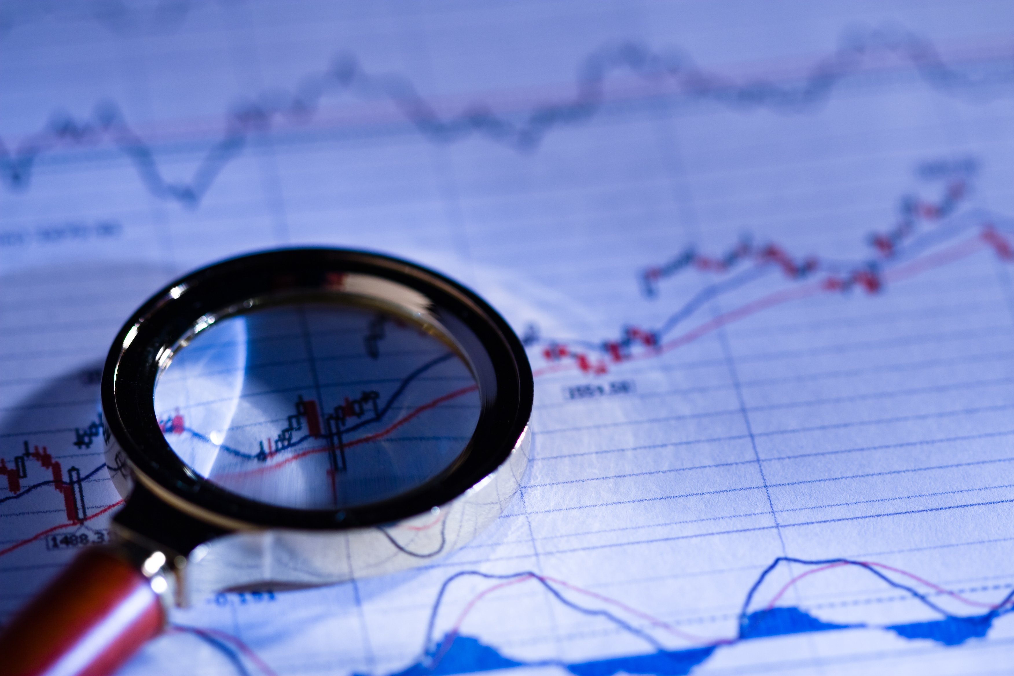 magnifying glass on top of stock chart