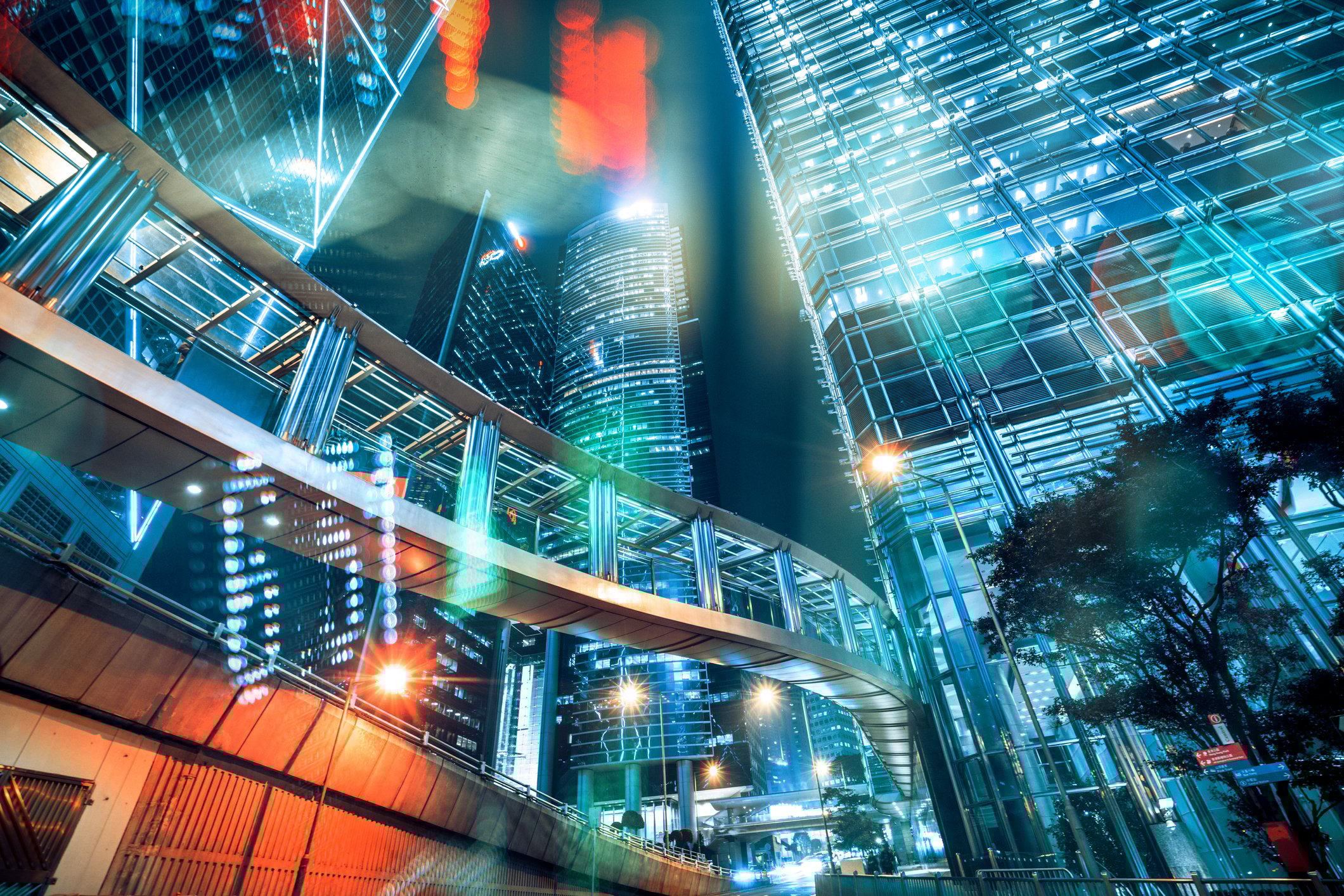 The Hong Kong skyline with stock tickers in the foreground.