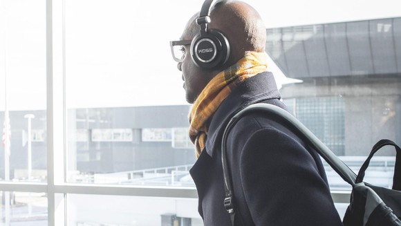 A man wears a pair of Koss headphones.