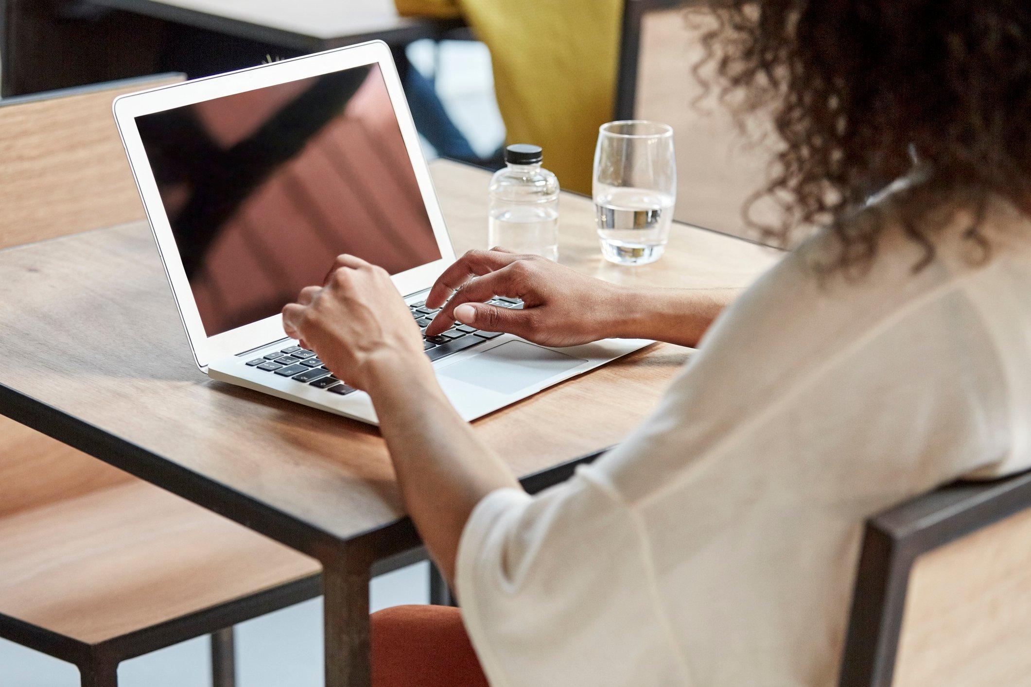 A woman using a laptop.