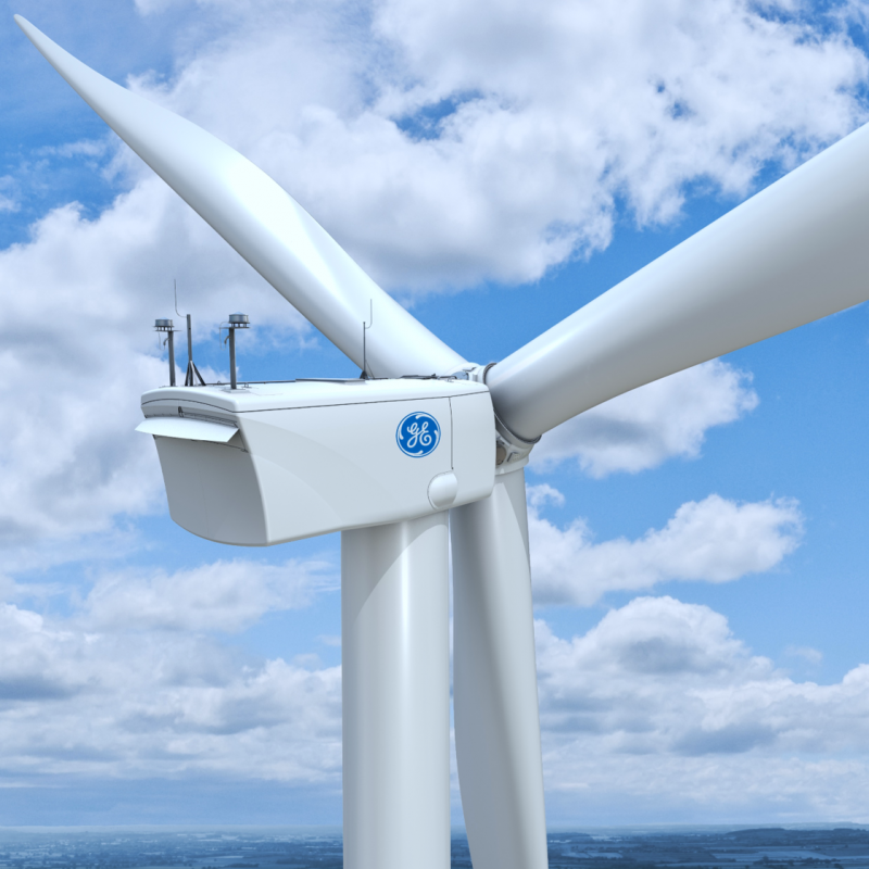 A General Electric windmill is shown with a blue sky and clouds in the background