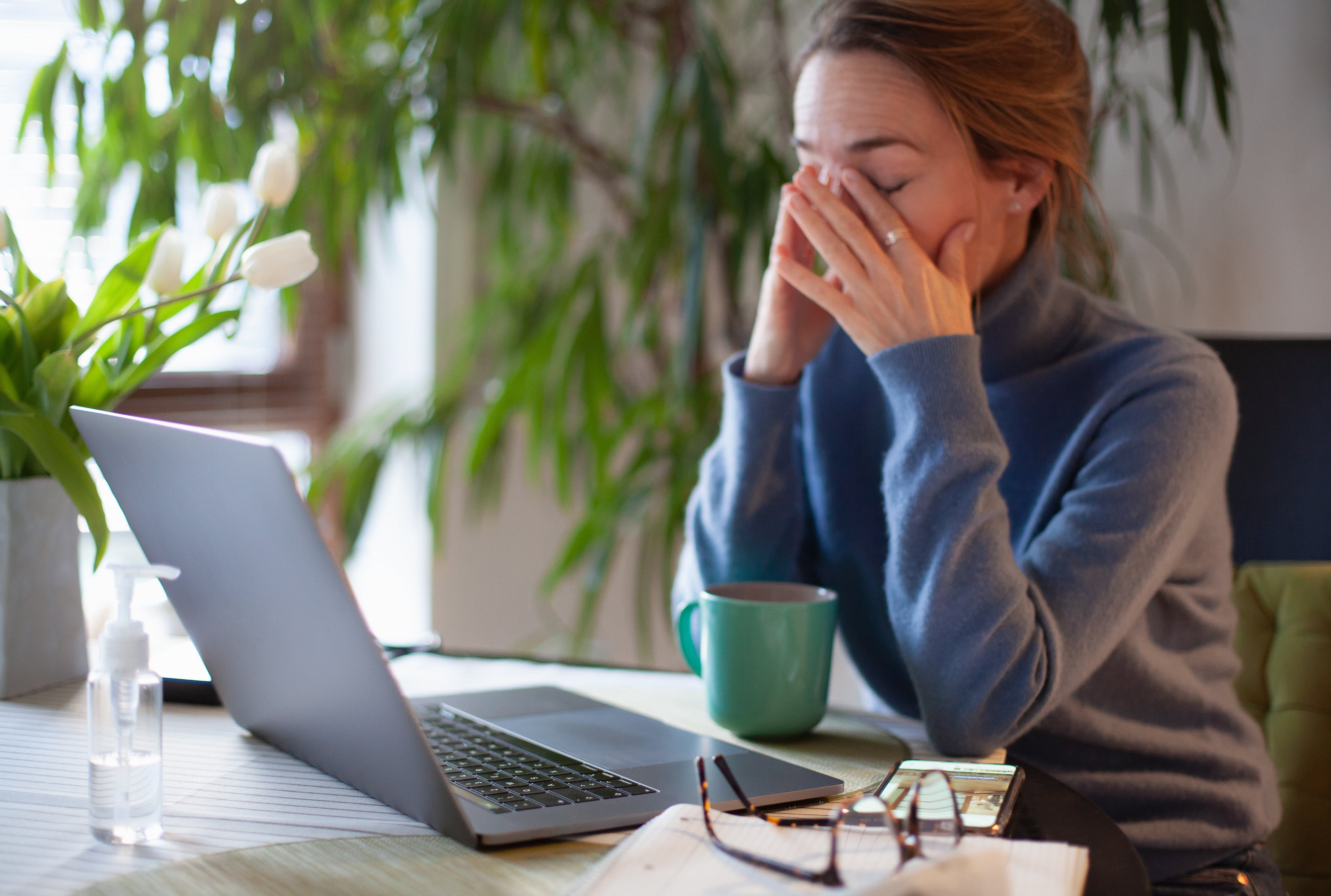 Woman stressed out while reading stock price movements. 