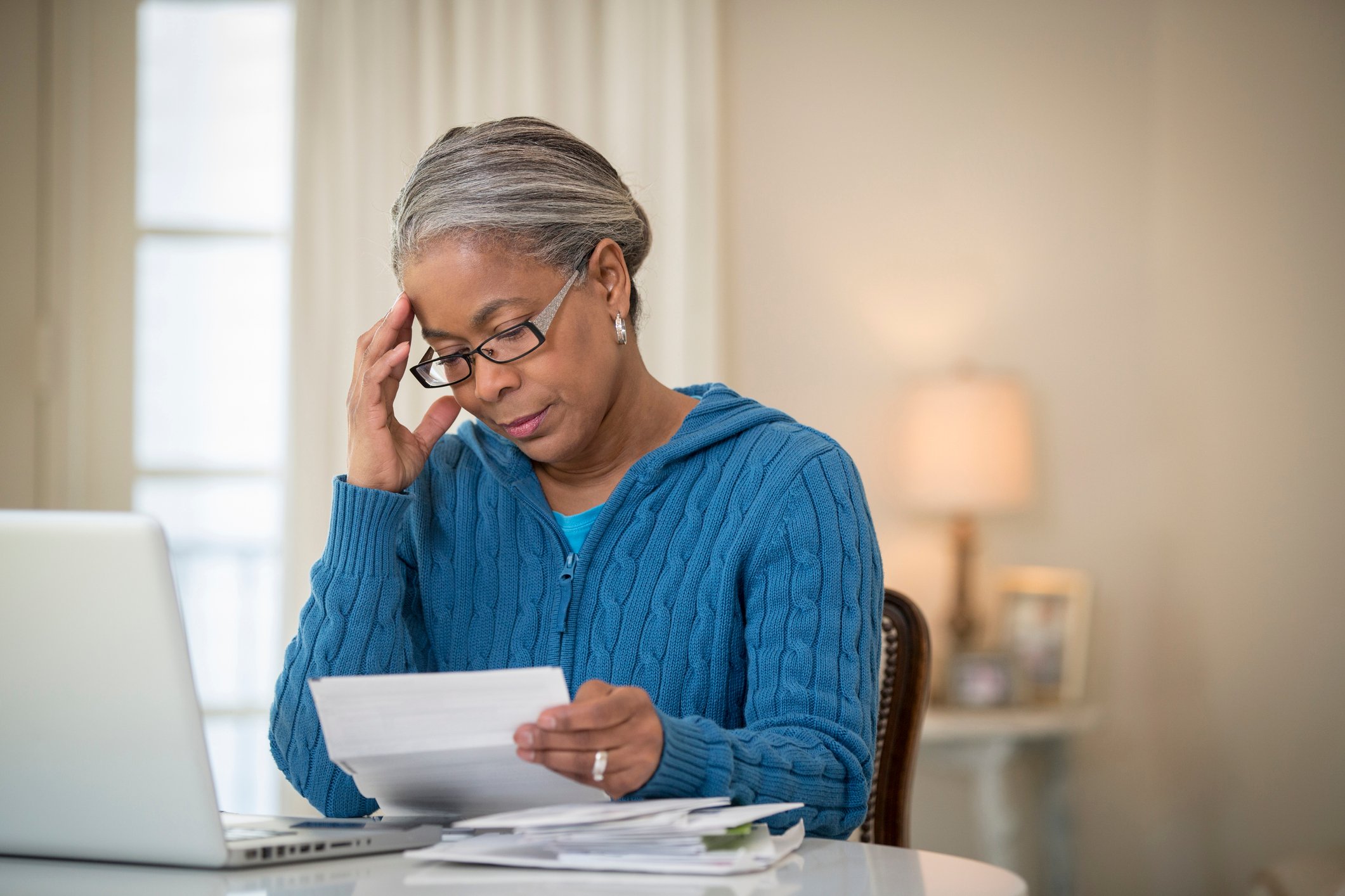 senior woman paying bills