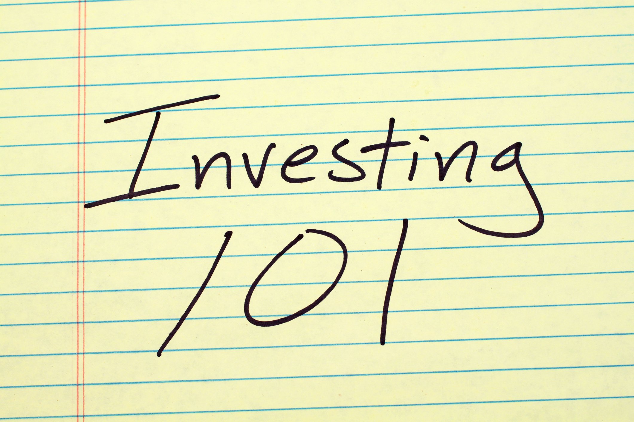 Investing 101 written on legal pad paper.