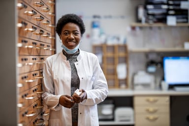 female pharmacist holds a bottle of medication