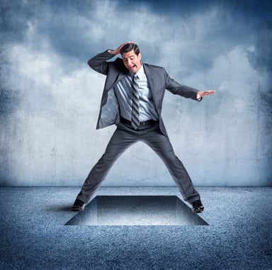 Man standing over a trap door