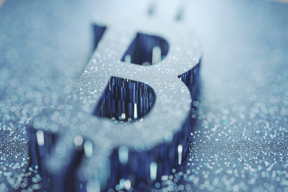 A 3-dimensional rendering of the Bitcoin symbol in blue.