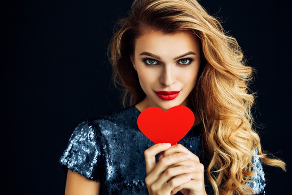Woman holding paper heart.