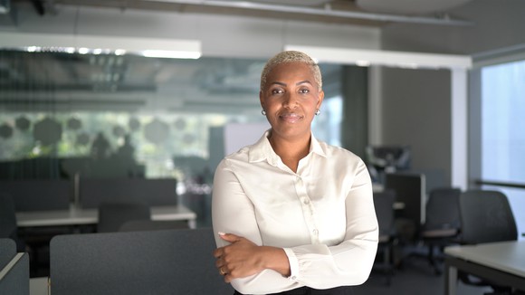 A businesswoman stands in an office space