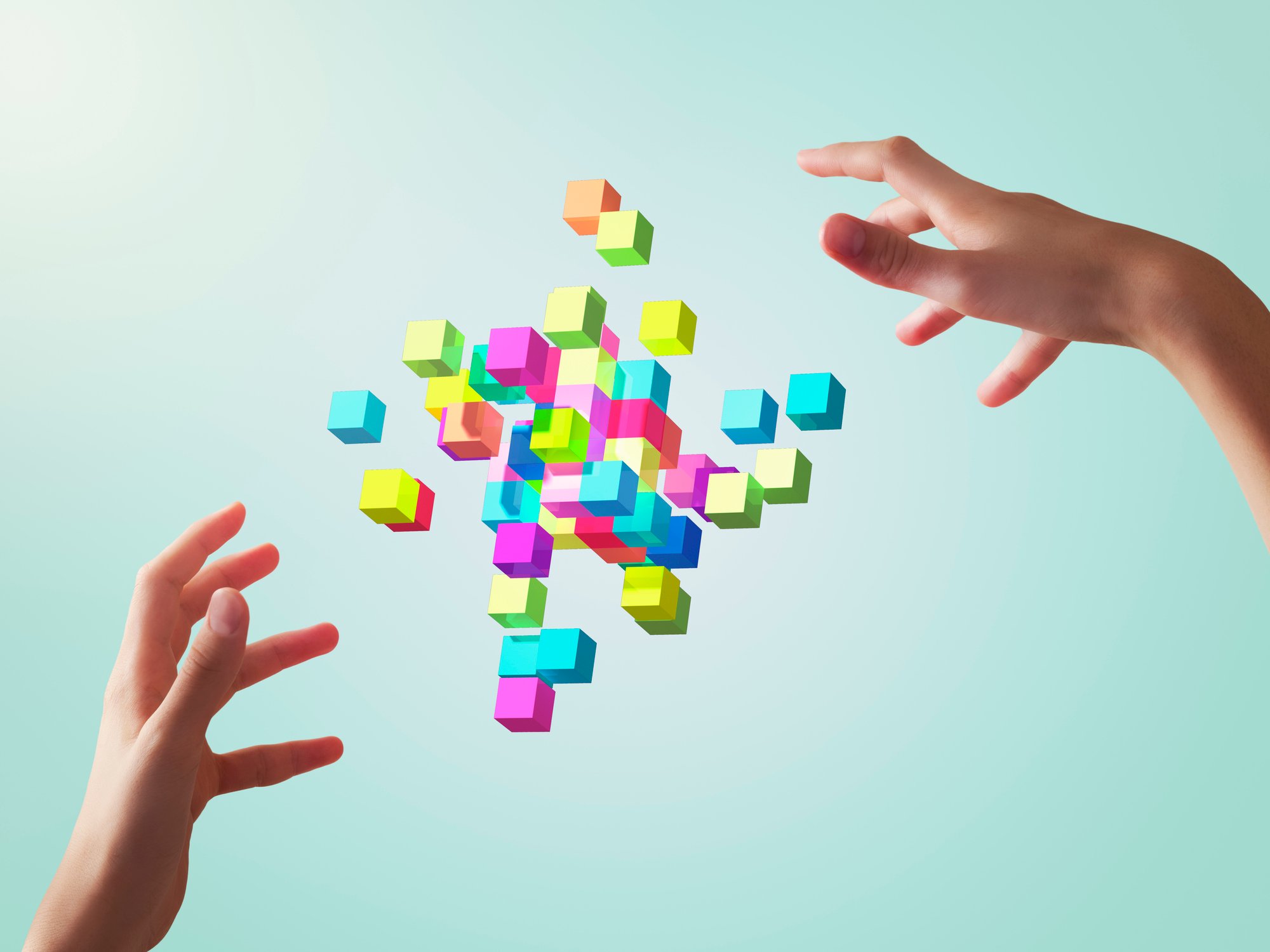 Two hands manipulating an augmented reality set of blocks.