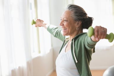 Older woman lifting small weights