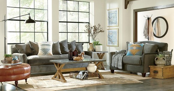 Room with couch, chair, table, and other furnishings.