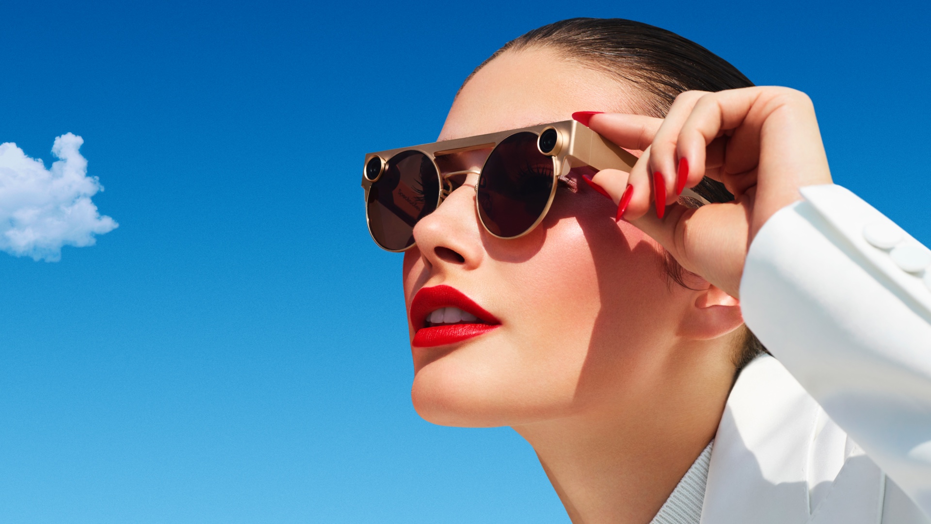 A woman wears a pair of Snapchat Spectacles.