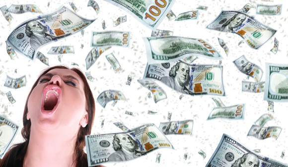 A woman screaming as $100 bills float around her.