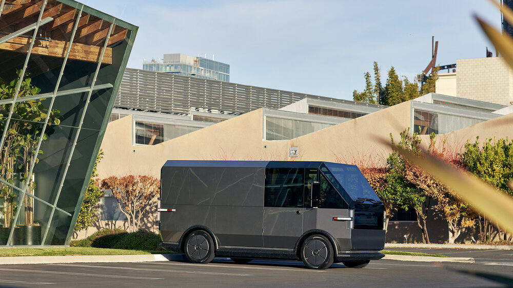 Canoo multi-purpose delivery vehicle (MPDV) parked outside a facility