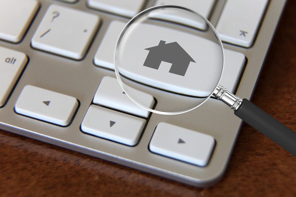 A magnifying glass over a keyboard key featuring a house icon.
