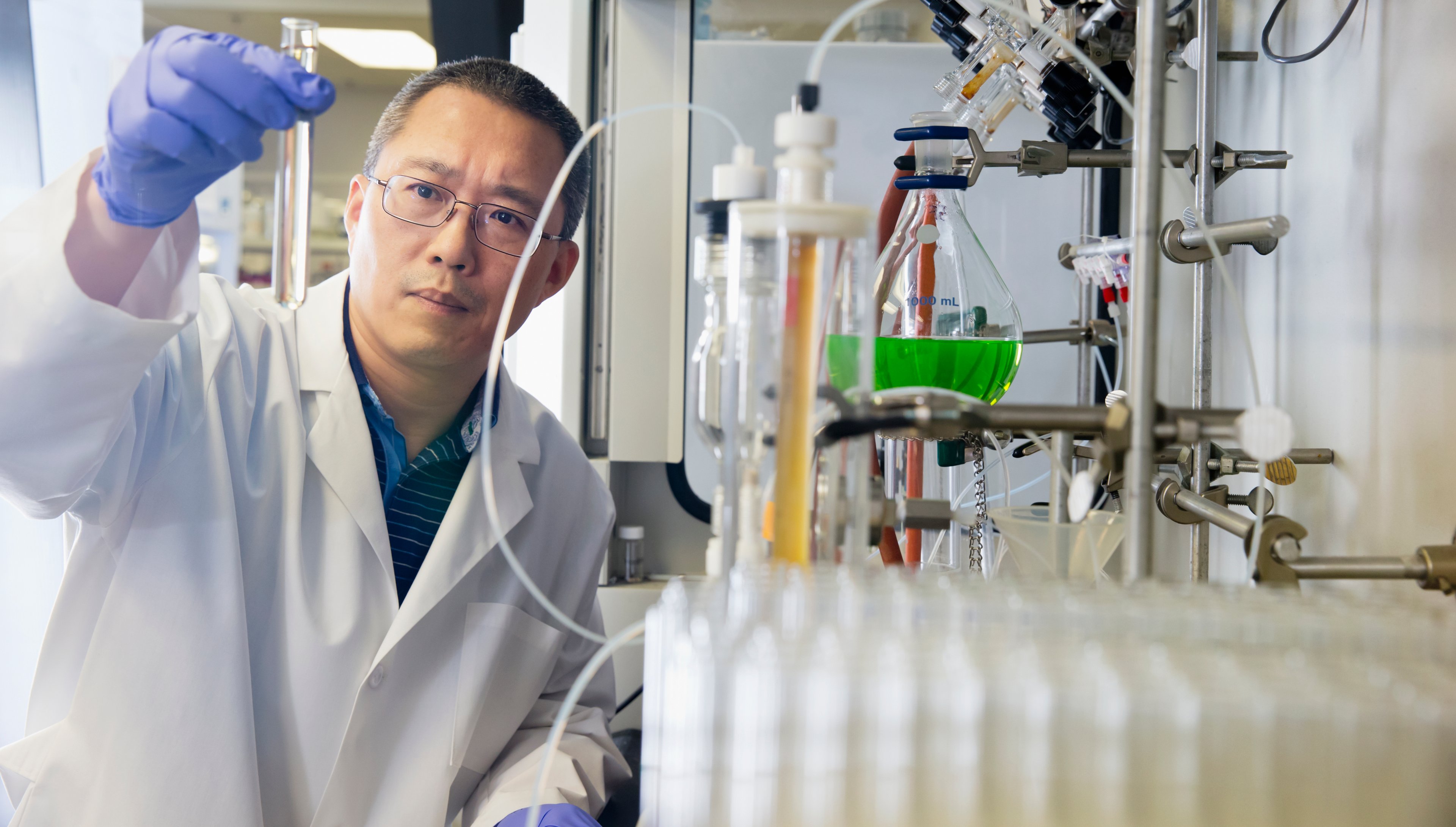 Scientist analyzing test tube. 