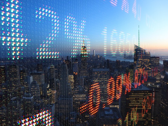 Cityscape overlaid with stock charts