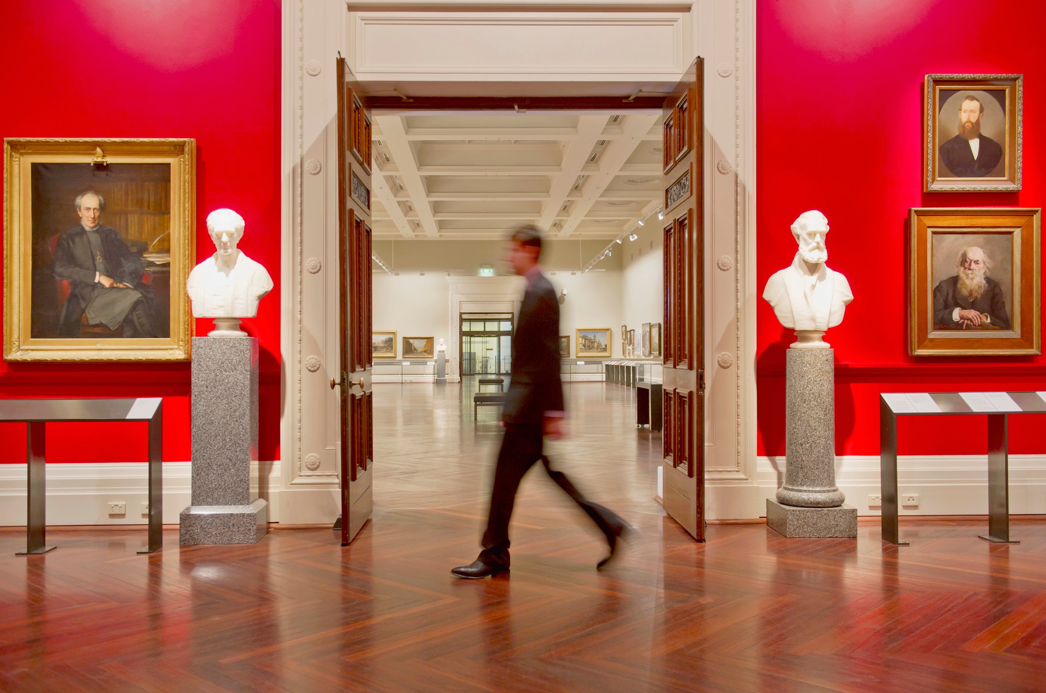 A security card walks through an art museum. 